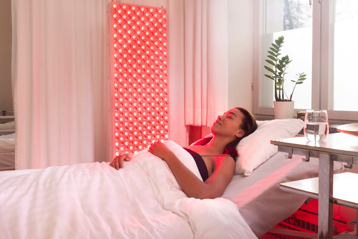 Woman resting in bed beside the lit The Red Kangaroo