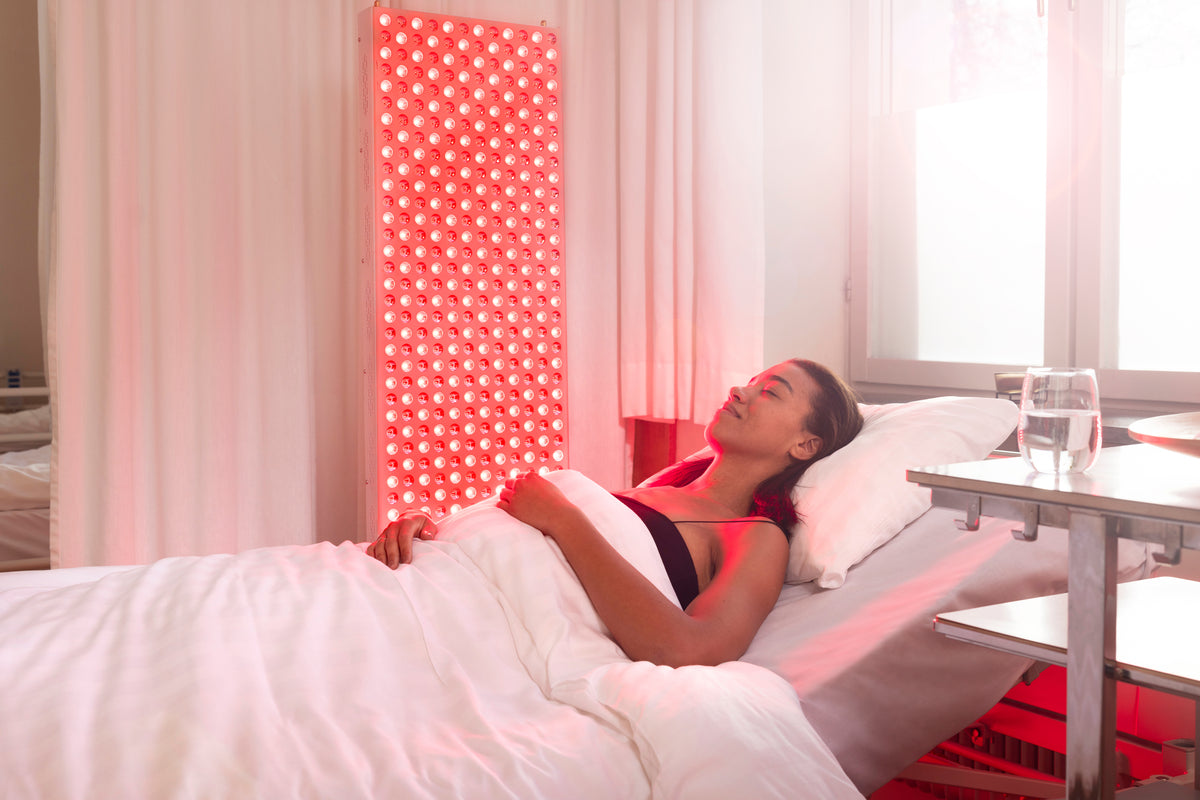 Woman rests in bed while The Red Kangaroo glows red beside her