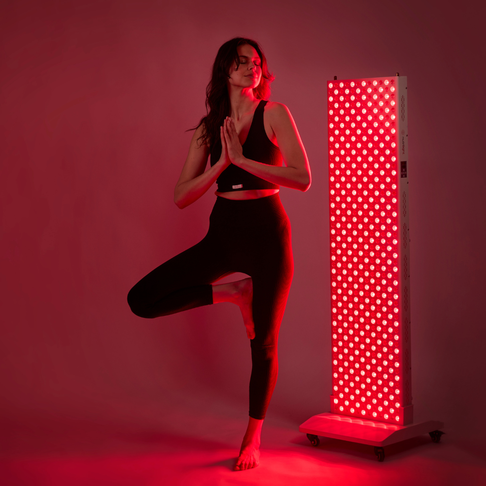 Woman standing in a yoga pose in front of The Red Kangaroo on a floor stand